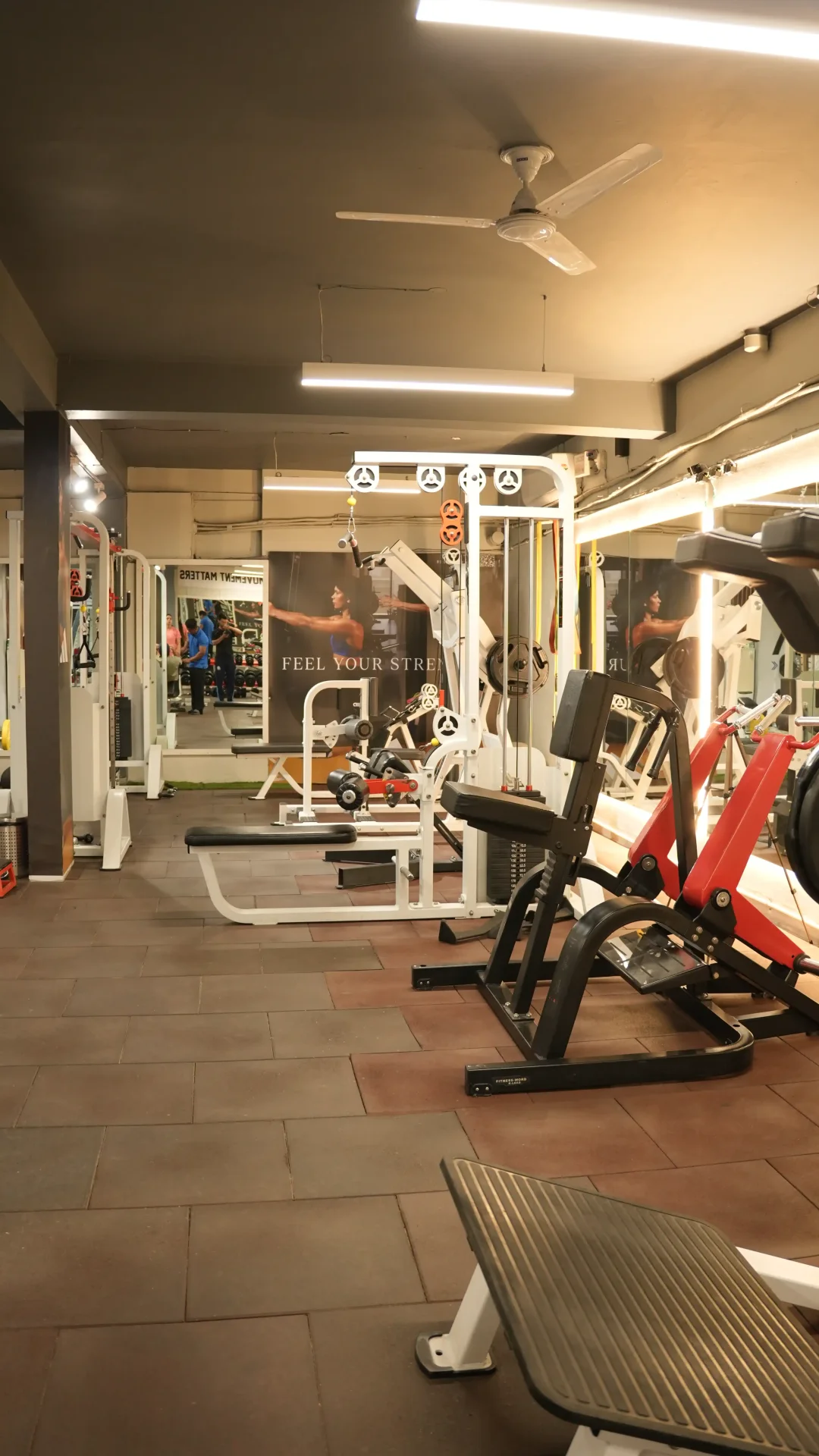 Training floor depth view with multiple cable and plate-loaded machines